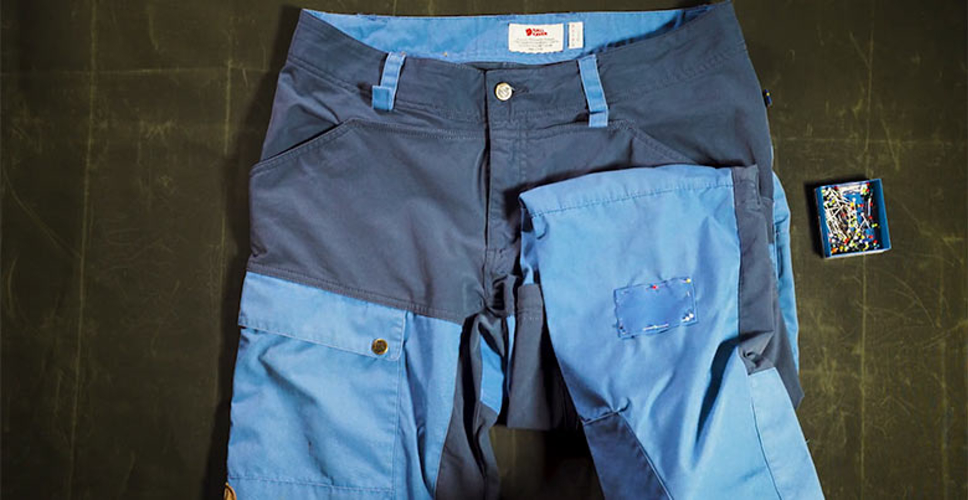 image of blue touring trousers with a patch